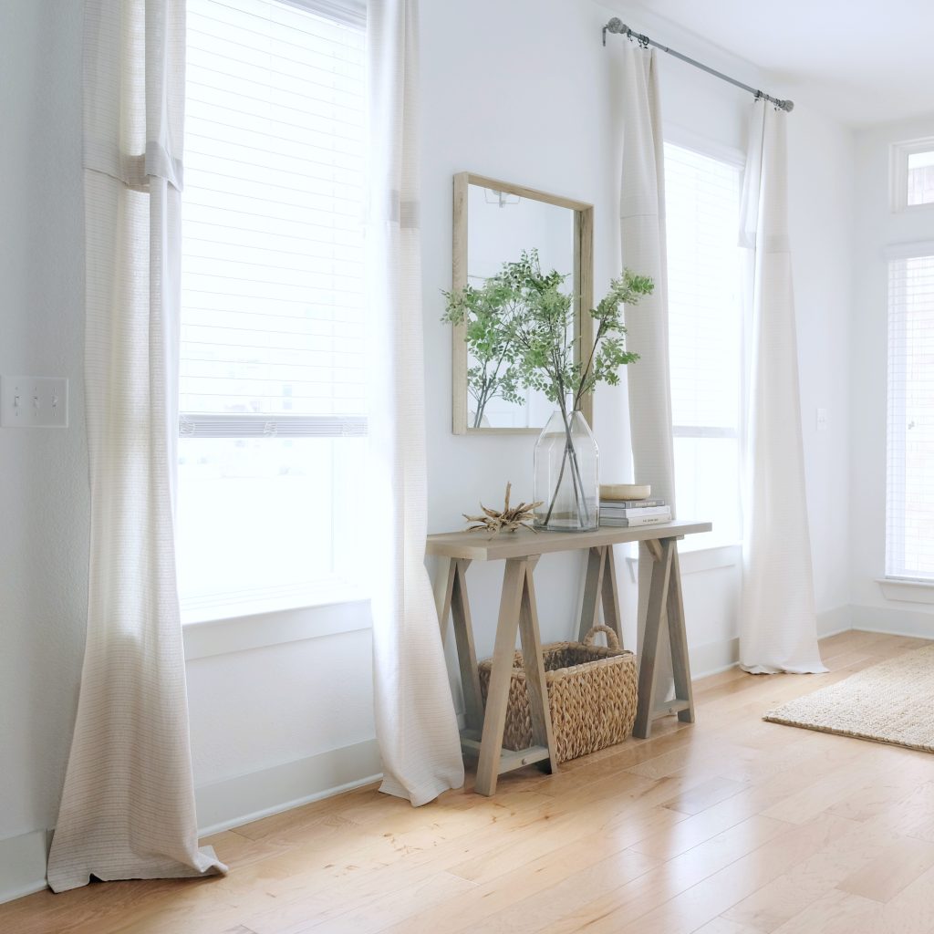 living room with neutral sofa and curtains